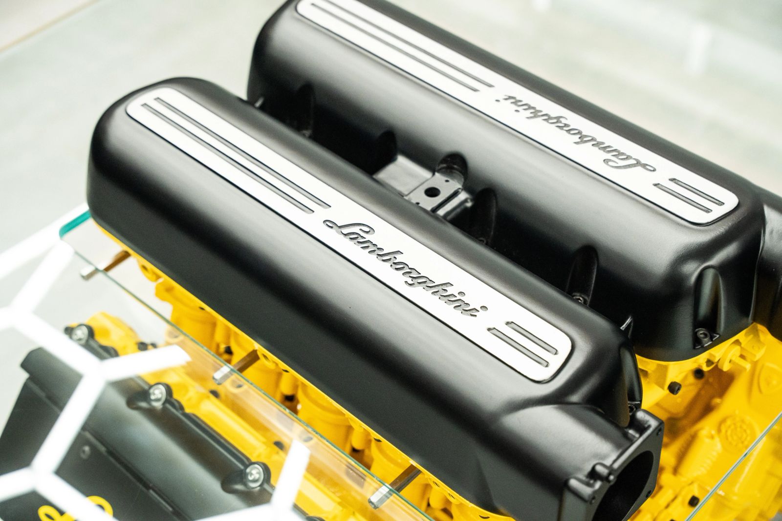 Close-up of black Lamborghini valve covers on a yellow block