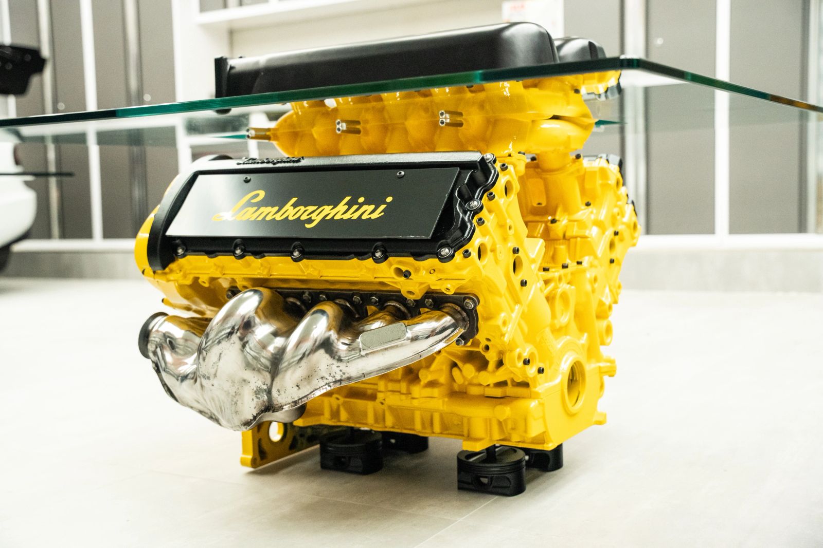 Yellow Lamborghini engine table with polished exhaust headers
